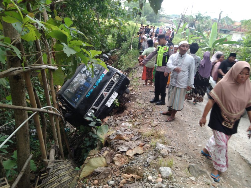 Caption: Kepolisan dan warga setempat saat melihat kondisi mobil Pick Up yang terjungkal diduga gagal nanjak di Desa Somber, Kecamatan Tambelangan, Kabupaten Sampang (Sumber Foto: Kasi Humas Polres Sampang)