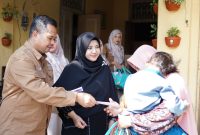 Caption: Direktur Utama Bank Sampang, Syaifullah Asyik, Didampingi Sang Istri dan Karyawan Bank Sampang Saat Memberikan Santunan Anak Yatim dan Kaum Dhuafa (Sumber Foto: Agus Junaidi/Pilar Pos)